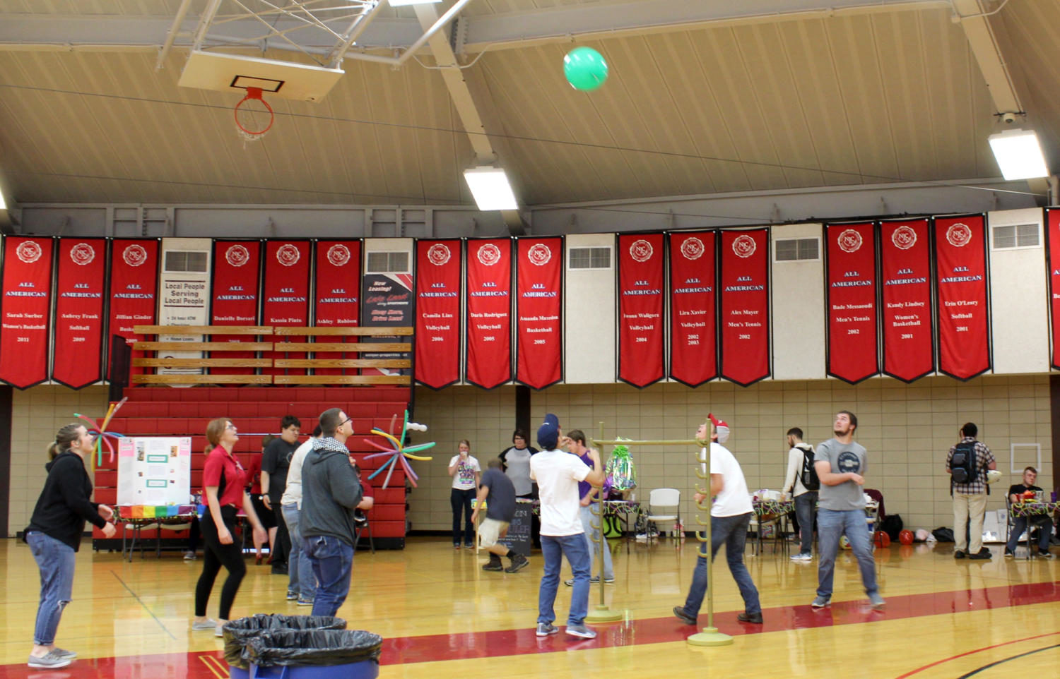 Student Life starts a game of punch balloon volleyball over the limbo stand.