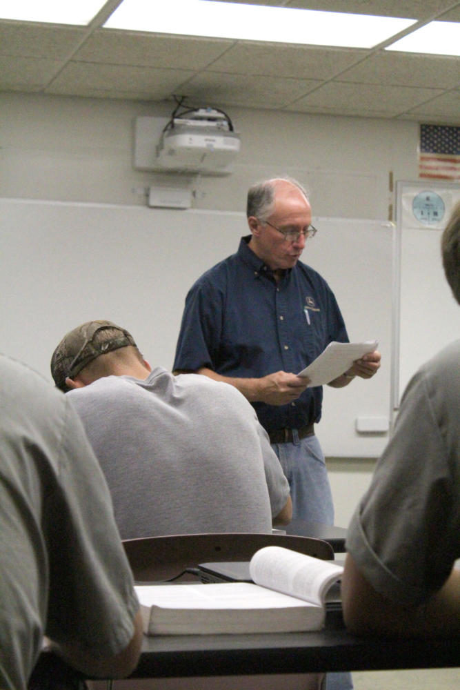 Drake teaches a John Deere Electrical systems class on Aug. 23. The class writes definitions as Drake reads them out.