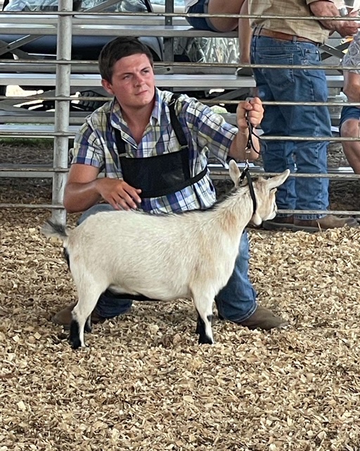 Clark poses with one of his goats. Photo provided by Brady Clark.