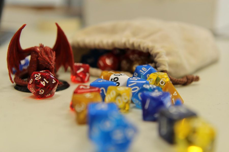 A+Red+Dragon+protects+his+hoard+of+Dungeons+and+Dragons+dice.%0APhoto+via+Adam+Alexander.