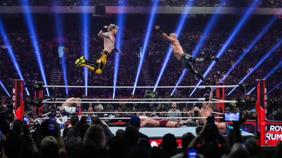 Logan+Paul+flies+through+the+air+to+collide+with+wrestler+Richochet+during+the+2023+Royal+Rumble.+Photo+via+Alex+Bierens+De+Haan.