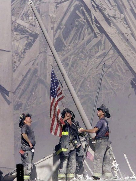 Firefighters raising the flag among the rubble at Ground Zero. Photo by Thomas E. Franklin.