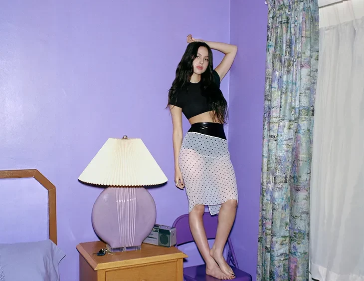 Olivia Rodrigo poses in a bedroom set-up for Variety to promote her new “bedroom pop” album. Photo from Variety via Larissa Hoffman.