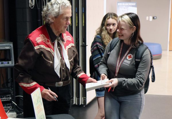 Temple Grandin signing a students copy of Visual Thinking, Grandins newest book. Photo by Aaron Wendt.