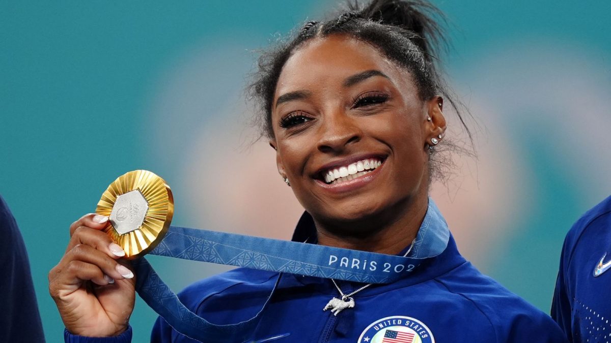 Here we have Simone Biles holding up one of her 2024 Olympic gold medals!