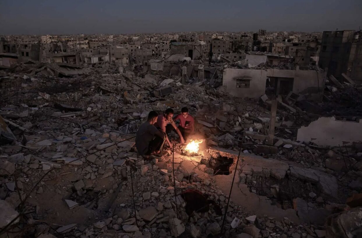 Palestinians gather around fire