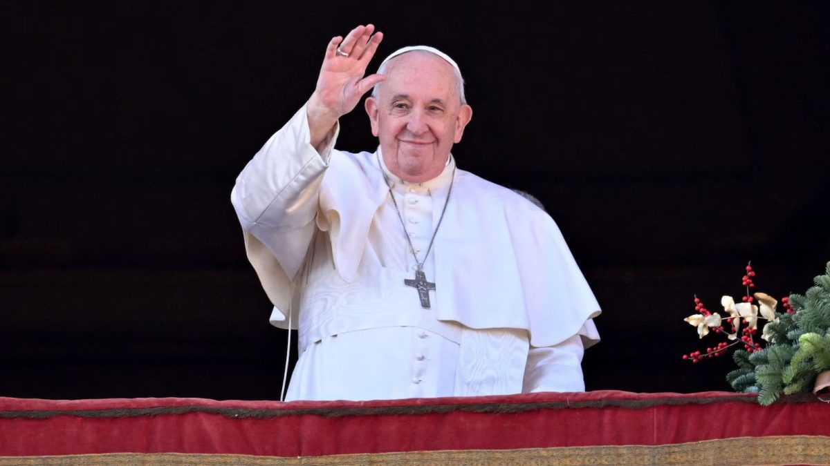 Pope Francis greets a crowd with a smile during a public appearance in Vatican City.