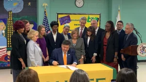 July 31, 2025, Gov. JB Pritzker signs universal mental health screenings into law at Chute Middle School in Evanston Illinois. 