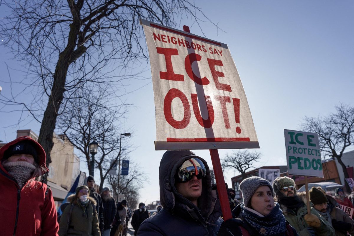 Demonstrators carry signs condemning Immigration and Customs Enforcement (ICE) near the site where Alex Pretti was fatally shot by federal agents.