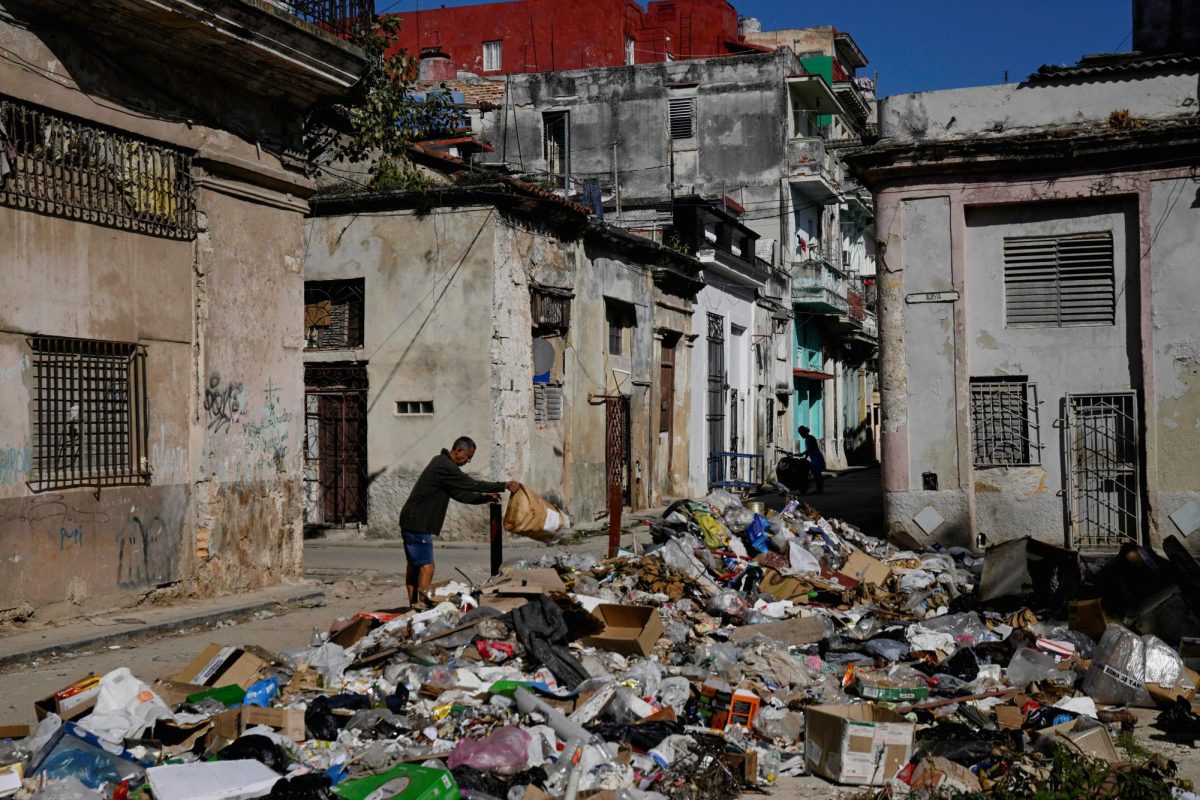 A man throws trash on a street in downtown Havana, Cuba, February 15, 2026.